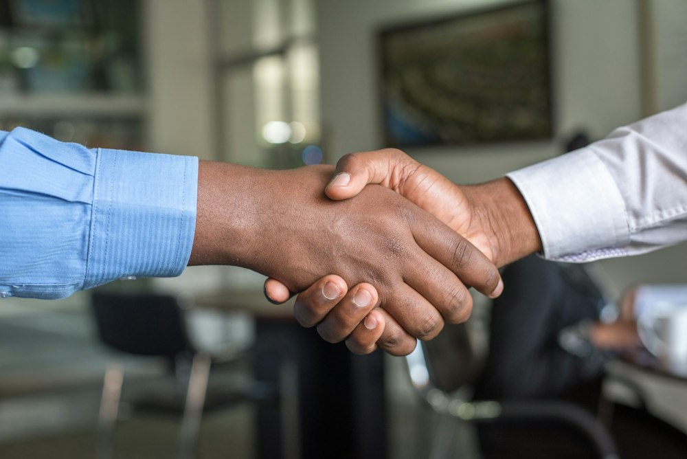 Business partners shaking hands after agreeing on a wealth growth strategy